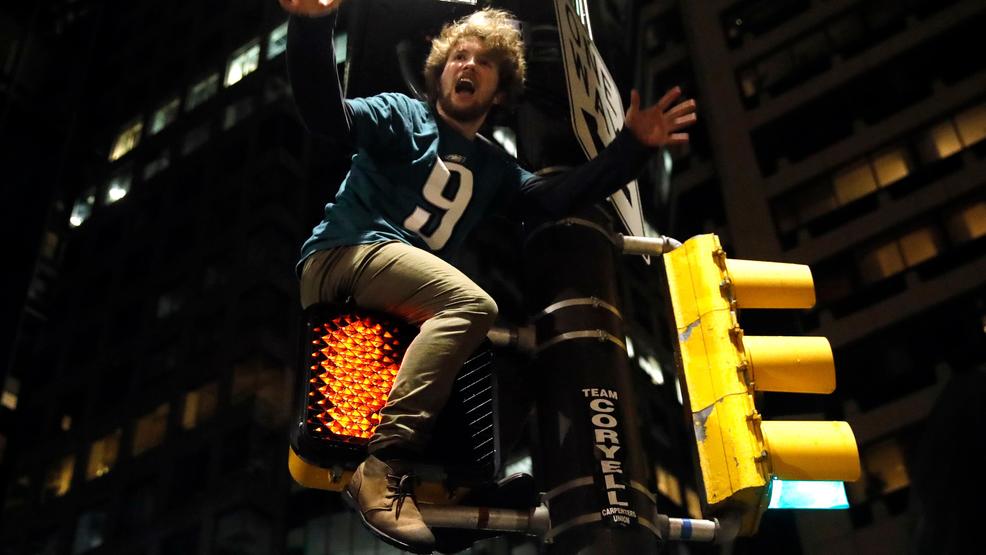 Eagles Patriots Super Bowl Reax Football SuperBowl LII fan climbs traffic walk sign AP6.jpg